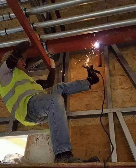 Ergonomie am Arbeitsplatz - Baustelle lustig mit Füßen schweißen